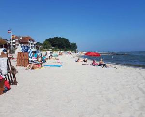 a group of people laying on a beach at Haus Sonne _ Meer in Sierksdorf +30 photos