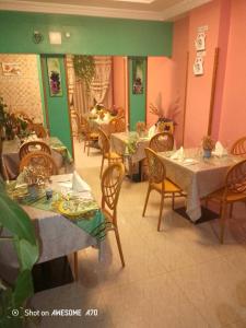 a restaurant with tables and chairs in a room at ALICIA Hôtel in Yaoundé