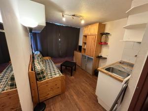a small room with a couch and a kitchen at Cool ski Tignes chalet relax in Tignes