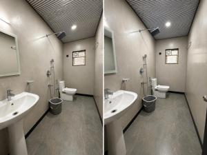 a bathroom with two sinks and two toilets at Baga beach heritage resort in Calangute +33 photos