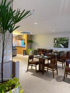 a living room with a table and chairs at Grand Maison Hotel in Porto Velho