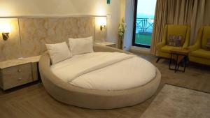 a bedroom with a large bed in a room at The Bliss avenue in Murree