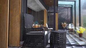 a patio with two chairs and a table on a porch at The Bliss avenue in Murree