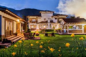 a large house with a yard with yellow flowers at Casa Fiorella in Villa de Leyva