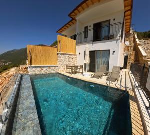 a villa with a swimming pool and a house at Aera Villas - Kaş in Kaş