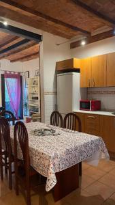 a kitchen with a table and some chairs and a table and a kitchen at Flat Plaza de España BCN in Barcelona