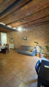 a living room with a couch and a brick wall at Flat Plaza de España BCN in Barcelona +16 photos