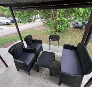 a group of chairs and a table on a porch at Smeštaj Stamenić in Bajina Bašta