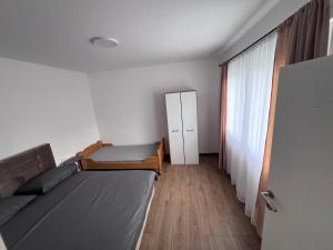 a small bedroom with a bed and a window at Smeštaj Stamenić in Bajina Bašta