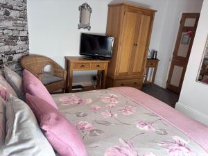 a living room with a bed and a tv at No 3 in Penrith