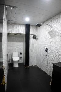a bathroom with a toilet and a shower at Divine View- Boutique Stay in Guwahati