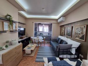 a living room with a couch and a table at Miranda's Apartments in Koskinou