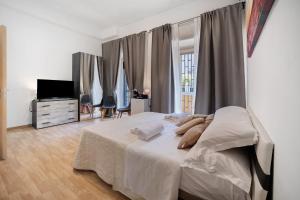 a bedroom with a large bed and a television at Home Joséphine - Caserta in Caserta