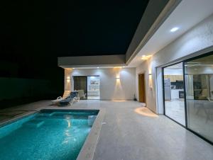 a swimming pool in the middle of a house at Azmouni in Midoun