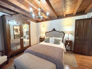 a bedroom with a large bed and a mirror at Vivienda Vacacional La Cocada VV-144-AS in Arriondas