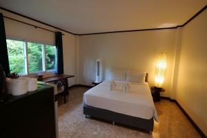 a bedroom with a large white bed and a desk at Garden Resort in Ko Chang +42 photos