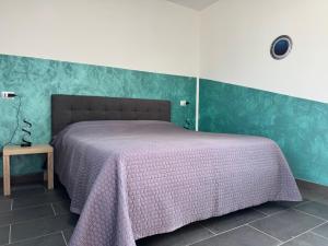 a bedroom with a bed with a pink blanket at Villa Melia Apartments in San Roberto
