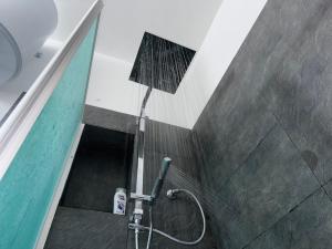 a shower stall in a bathroom with a shower at Villa Melia Apartments in San Roberto +67 photos