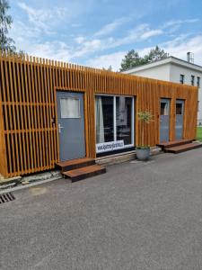 an orange building with two doors and a fence at Apartmány Karolínka in Karolinka +3 photos