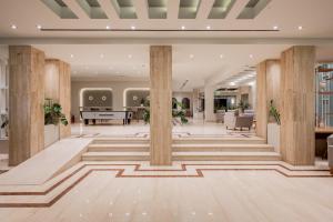 an office lobby with columns and a reception at Hotel Palmyra in Argassi +106 photos