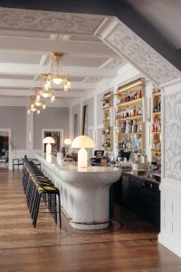 a bar with a marble counter and chairs in a room at Hotel GRACE LA MARGNA ST MORITZ in St. Moritz +132 photos