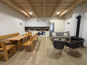 a living room with a table and chairs and a couch at Csitári-patak Vendégház in Csitár
