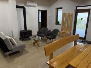 a living room with a couch and a wood stove at Csitári-patak Vendégház in Csitár