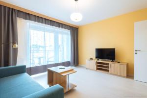 Televízia a/alebo spoločenská miestnosť v ubytovaní Apartament Posejdon Kołobrzeg