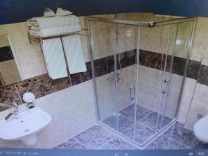 a bathroom with a shower and a sink at FAVORİTE Hotel in Söğütlü