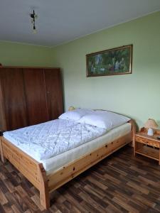 a bedroom with a bed with a wooden frame at Einfamilienhaus 