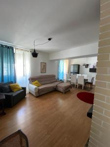 a living room with a bed and a couch and a table at Casa Ferreira in Beja