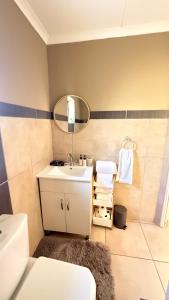 a bathroom with a sink and a mirror at 2 Bedrooom Self Catering Unit, East London, 5241, South Africa, KuGompo City in Dorchester Heights  +46 photos