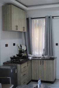 a kitchen with a sink and a stove at Sky Beach Resort in Kisumu