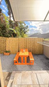 a wooden table sitting in front of a fence at 2 Bedrooom Self Catering Unit, East London, 5241, South Africa, KuGompo City in Dorchester Heights 