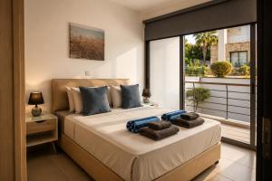 a bedroom with a large bed with towels on it at Blue Infinity Villa 33 in Neo Chorio