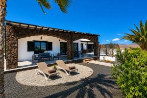 a house with two chairs and a patio at Sea Star Lanzarote in Playa Blanca