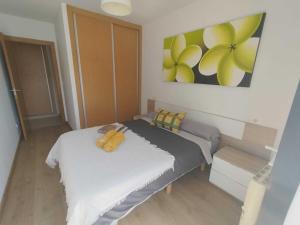 a bedroom with two beds and a painting on the wall at Confortable piso en Ares in Ares