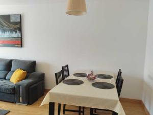 a living room with a table and a couch at Confortable piso en Ares in Ares