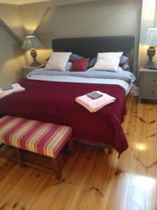 a bedroom with a large bed with a wooden floor at Luxury 1 Bed-Room Flat 65m2 in Görlitz