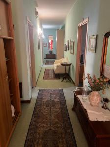 a hallway with a room with a couch and a table at Albergo Milena in Gardone Val Trompia