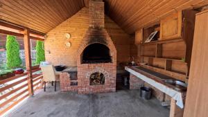 a brick oven in a kitchen with a table at CASA R&D in Moisei