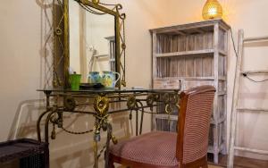 a glass table with a chair and a mirror at GWK View Boutique Hotel and Serviced Residence in Jimbaran