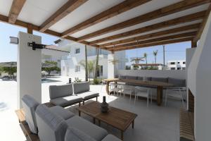 a patio with a table and chairs and a dining room at Azoria Villa in Haraki