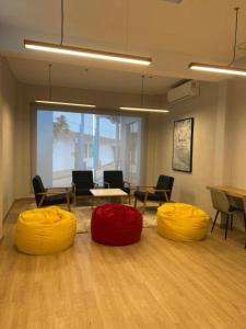three ottomans in an office with chairs and tables at Mutiara Melaka Beach Resort Condominium,Pantai Puteri Melaka in Malacca +34 photos