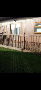 a wooden fence in front of a house at 2 Bedroom cosy chalet Mablethorpe in Mablethorpe