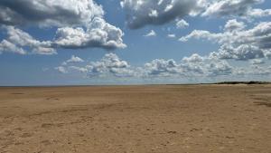 an empty field with clouds in the sky at 2 Bedroom cosy chalet Mablethorpe in Mablethorpe