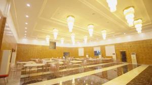 a dining hall with tables and chairs and lights at Exclusive Serene Hotel Abuja in Abuja