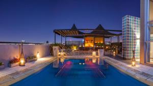 a swimming pool in front of a building at night at Be Hollywood! in Buenos Aires