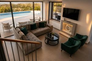 a living room with a couch and a tv at Blue Infinity Villa 33 in Neo Chorio