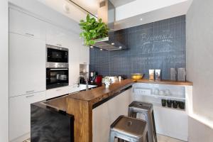 a kitchen with white cabinets and a counter top at Haddar Etna in Zafferana Etnea